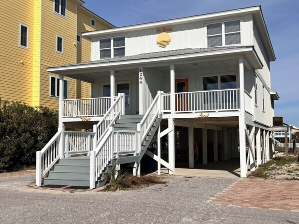 A two-story building with a balcony and a staircase leading to the second floor.