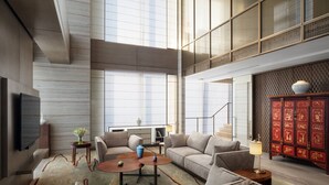 A spacious living area with a high ceiling, large windows, and a traditional red cabinet.