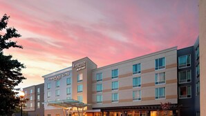A Fairfield Inn & Suites by Marriott hotel with a modern design, featuring a covered entrance and a well-lit facade.