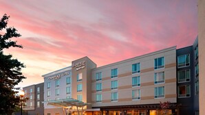 A Fairfield Inn & Suites by Marriott hotel with a modern design, featuring multiple floors and a covered entrance. - TownePlace Suites by Marriott Louisville Northeast (Louisville)