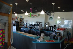A coffee bar with a counter, various coffee machines, and hanging lights. - 🌊Things are different at the beach!  Best time for a beach getaway!🌊🏖️🌴🌴 (Gulf Shores)