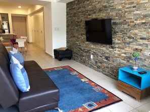 Departamento Confort | Sala de estar | Televisión de pantalla plana 