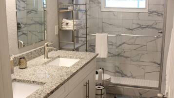 Combined shower/bathtub, hair dryer, towels, soap