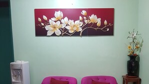 A living room with two purple sofas, a coffee table, and a water dispenser. - Desiree's Lodge And Transient House, Baler Aurora (Baler)