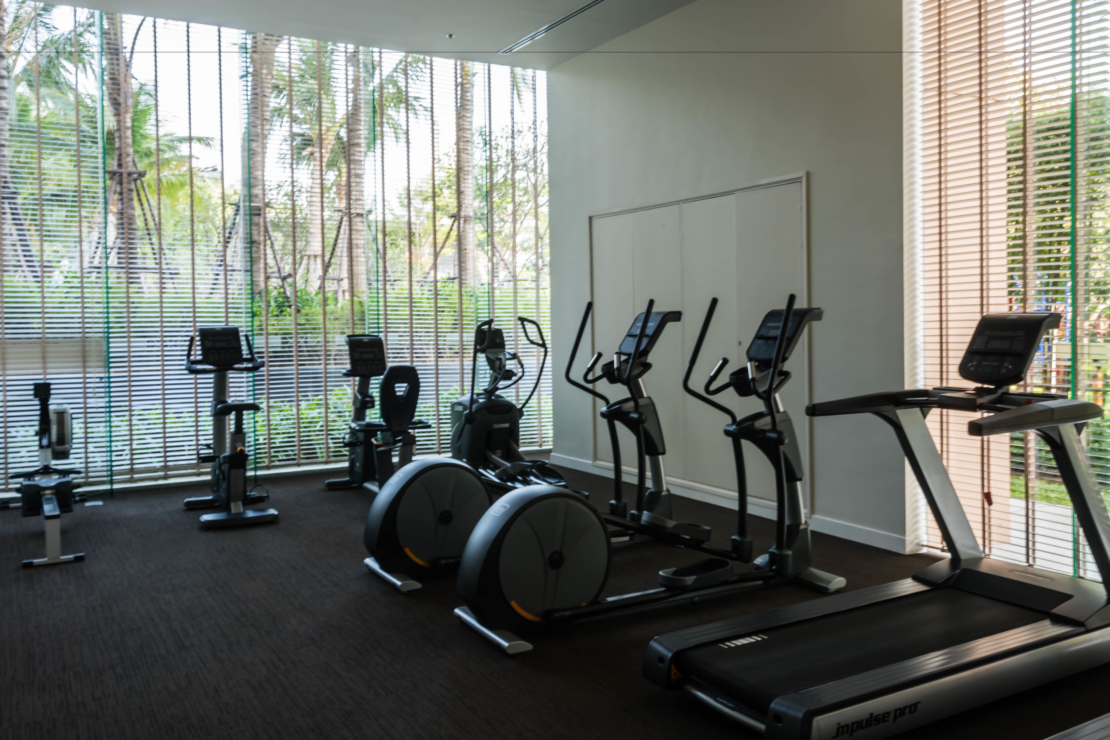 A gym with stationary bikes, elliptical machines, and treadmills.