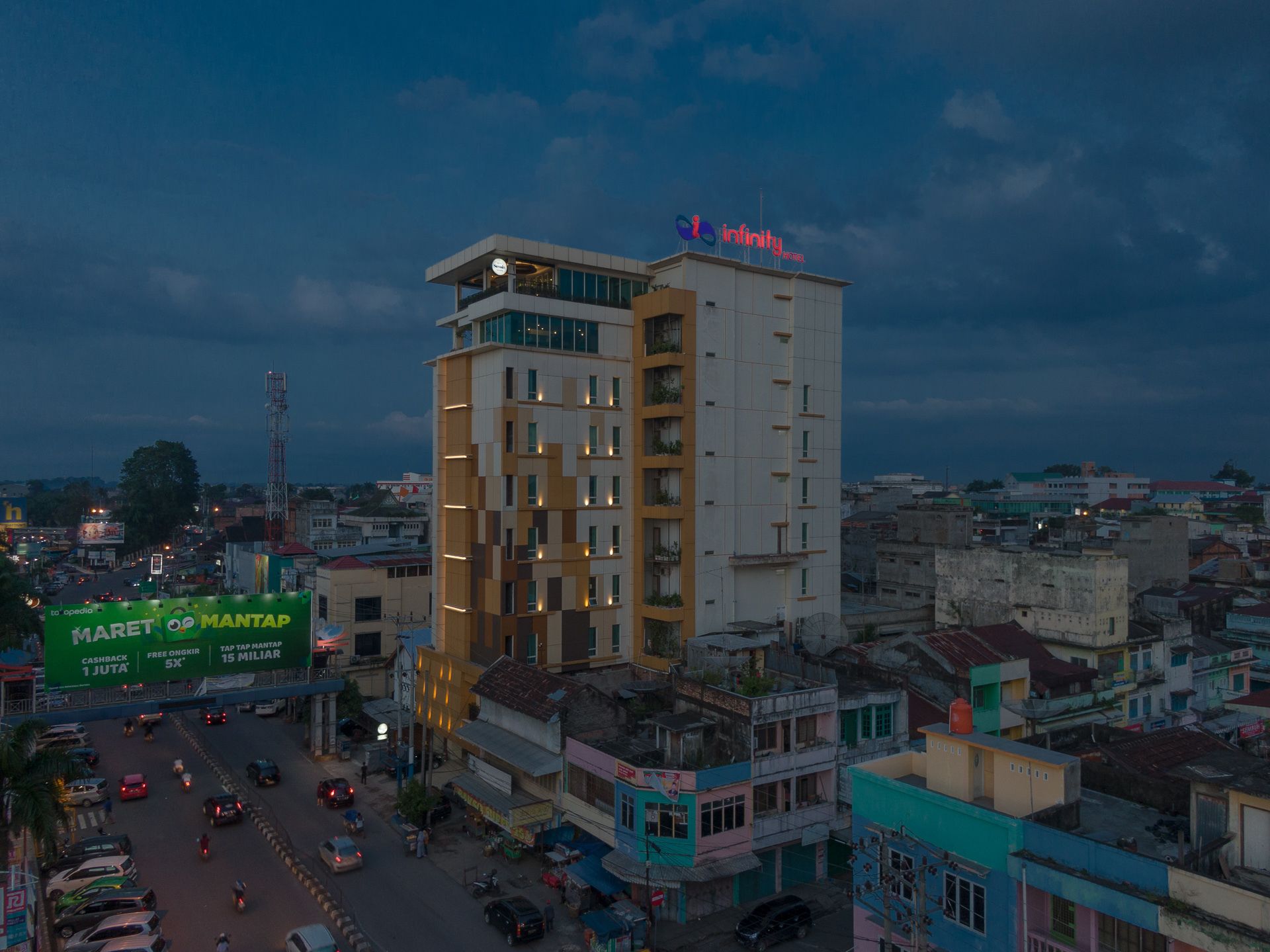 A multi-story hotel with a modern design, featuring balconies and large windows.