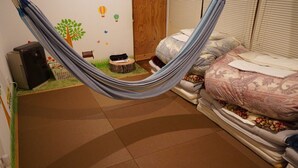 A room with a bed, a hammock, a desk, and a computer. - Yado Poppoya (Tsuru)