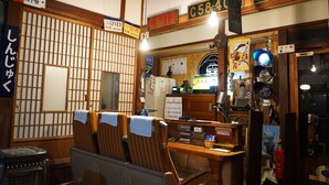 A traditional Japanese room with tatami flooring, a wooden desk, and a shoji screen. - Yado Poppoya (Tsuru)