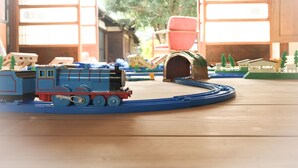 A model train set on a track with a tunnel and small buildings in the background. - Yado Poppoya (Tsuru)