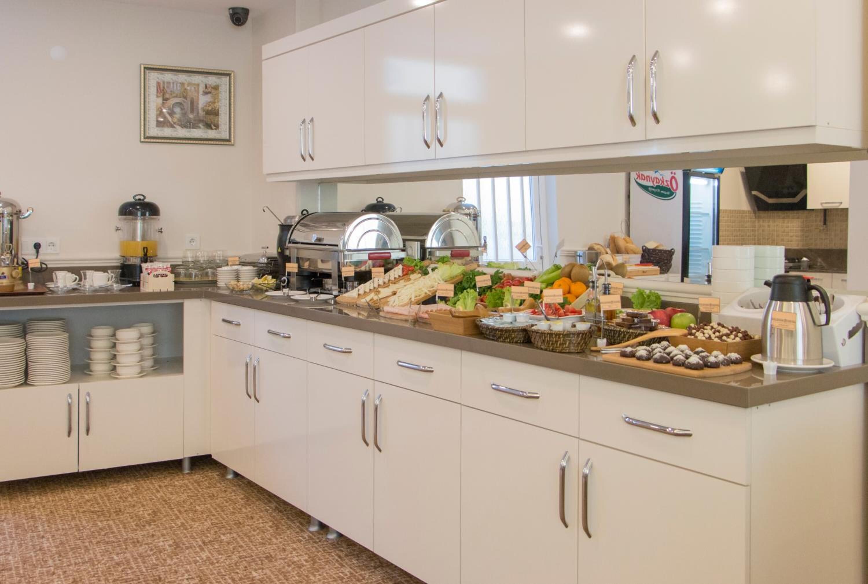 A buffet-style breakfast setup with various food items and beverages.