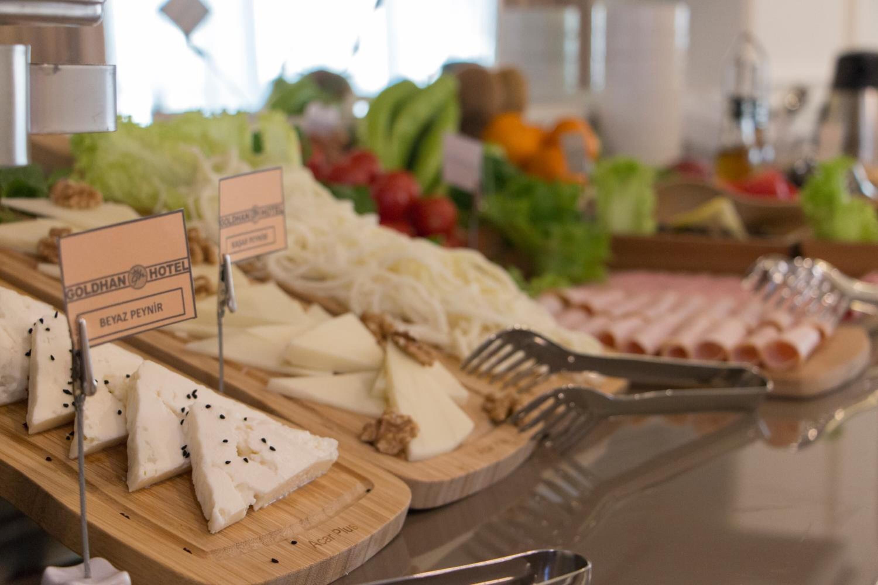 Een buffet met verschillende kazen, soorten fruit en groenten.