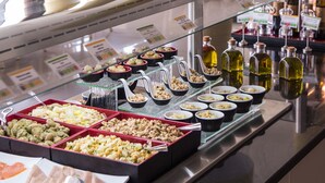 A buffet with various food items and condiments.