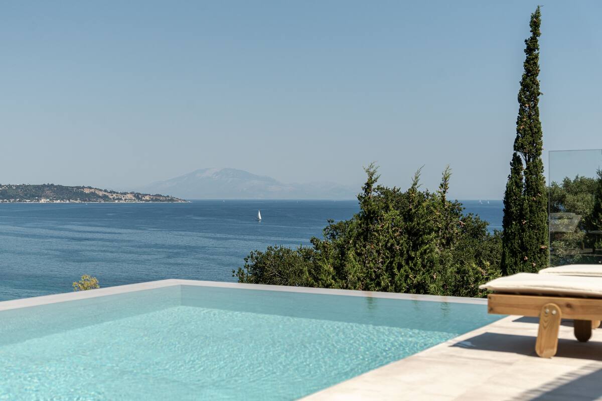 A clear view of a swimming pool with a mountain in the background.