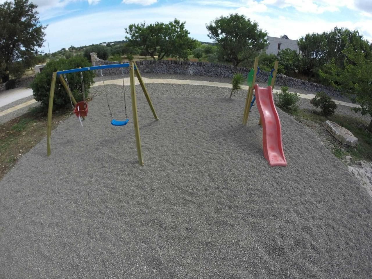 A playground with a swing set and a slide.