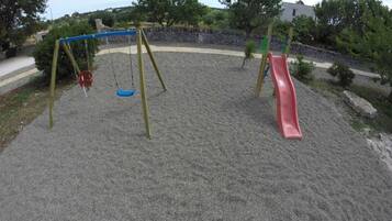 A playground with a swing set and a slide.