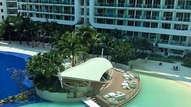 A resort with a pool, lounge chairs, and umbrellas. - Maui 2 Bedroom Condo at Azure Urban Resort Residences (Parañaque)