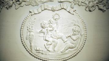 A detailed architectural carving with a circular motif, possibly a decorative element on a wall or ceiling.