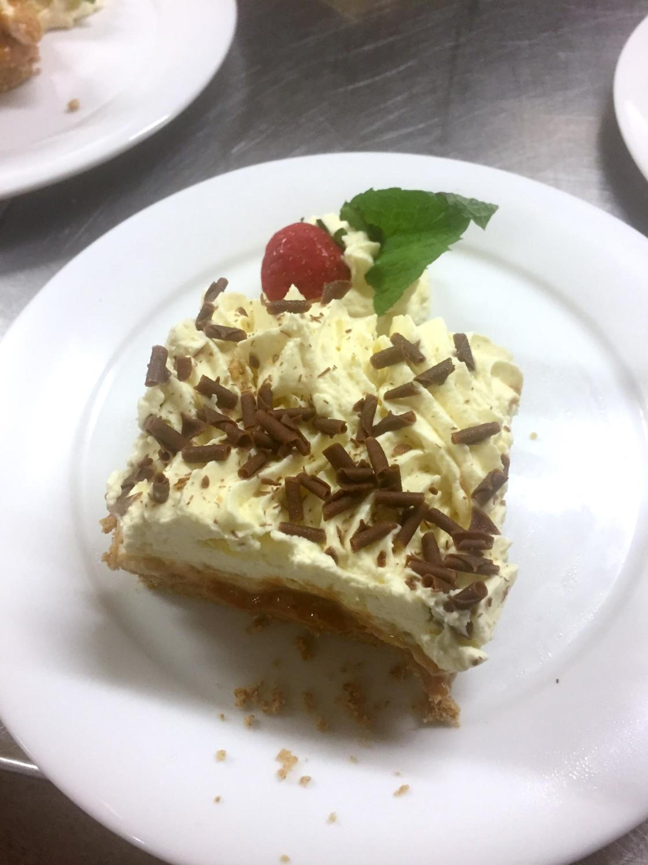 A slice of layered dessert on a white plate.