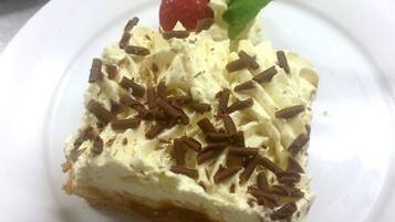 A slice of layered dessert on a white plate.