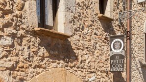 A stone building with a sign reading "El Petit Con Vent". - Hotel el Petit Convent (Begur)