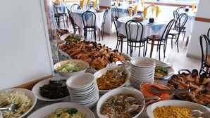 A buffet with various dishes including seafood, salads, and pasta. - Hotel Caravan (Pesaro)