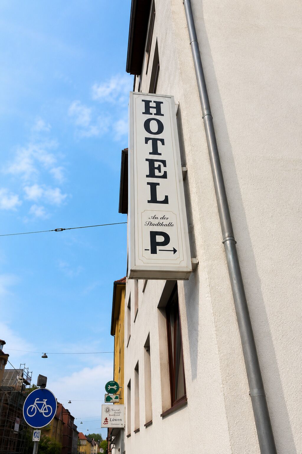 Een hotelschild met 'HOTEL' en een 'P' om parkeren aan te duiden.