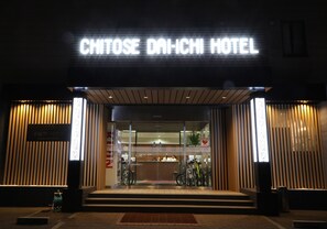 The entrance to the Chitose Daiichi Hotel with a modern design, featuring a reception desk and bicycles outside. - Chitose Daiichi Hotel (Chitose)