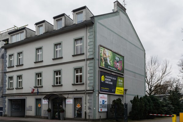 A multi-story building with a storefront labeled "ANTICA" at the ground level.