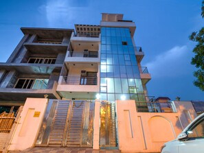 A multi-story building with a modern design, featuring balconies and large windows. - OYO 2807 Hotel Crosswinds Residency (Noida)