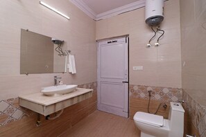 A bathroom with a sink, mirror, toilet, and shower. - OYO 10661 DSR Classic (Noida)