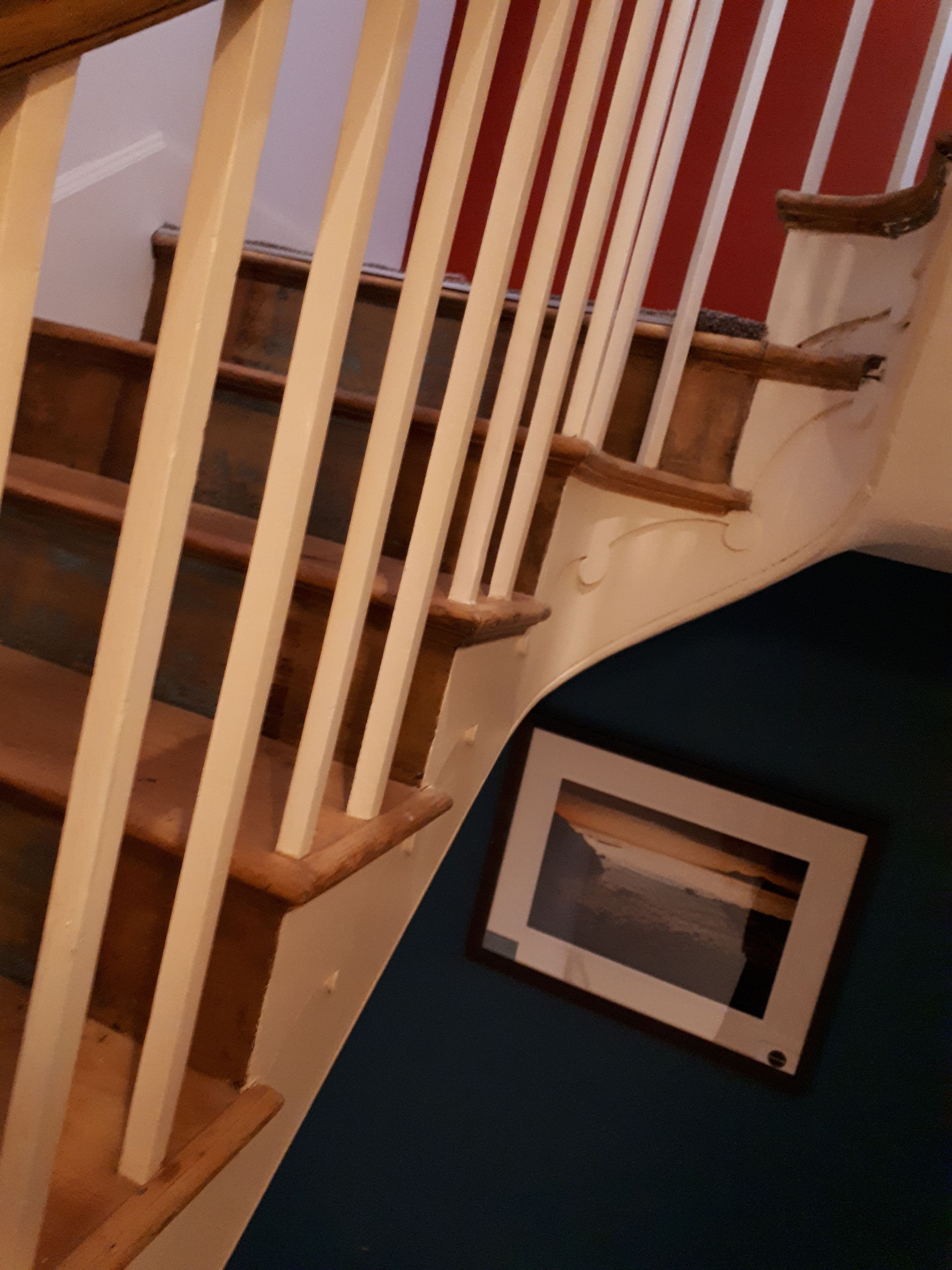 A staircase with wooden steps and white balusters.