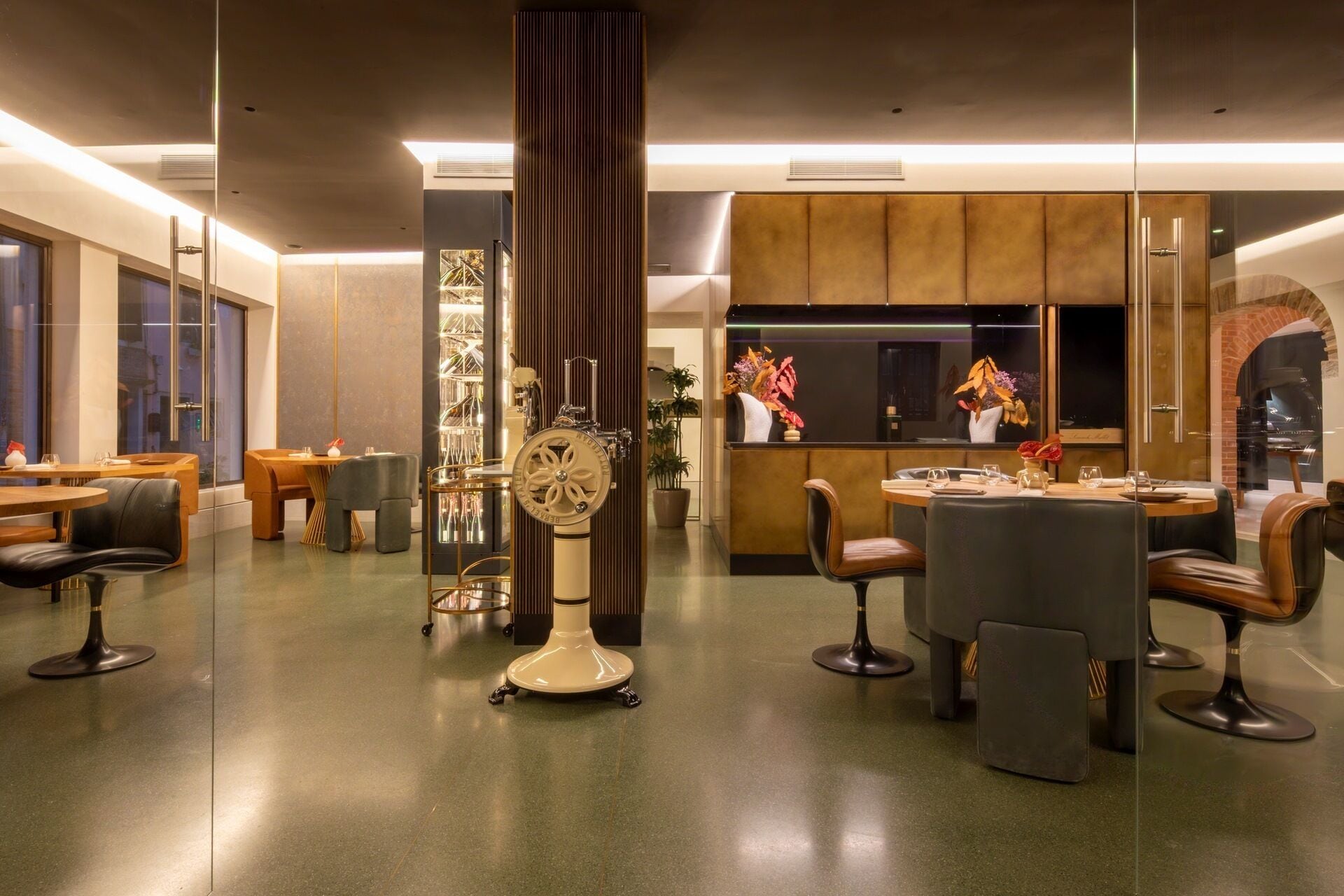 A modern hotel lobby with a reception desk, seating area, and a decorative clock.