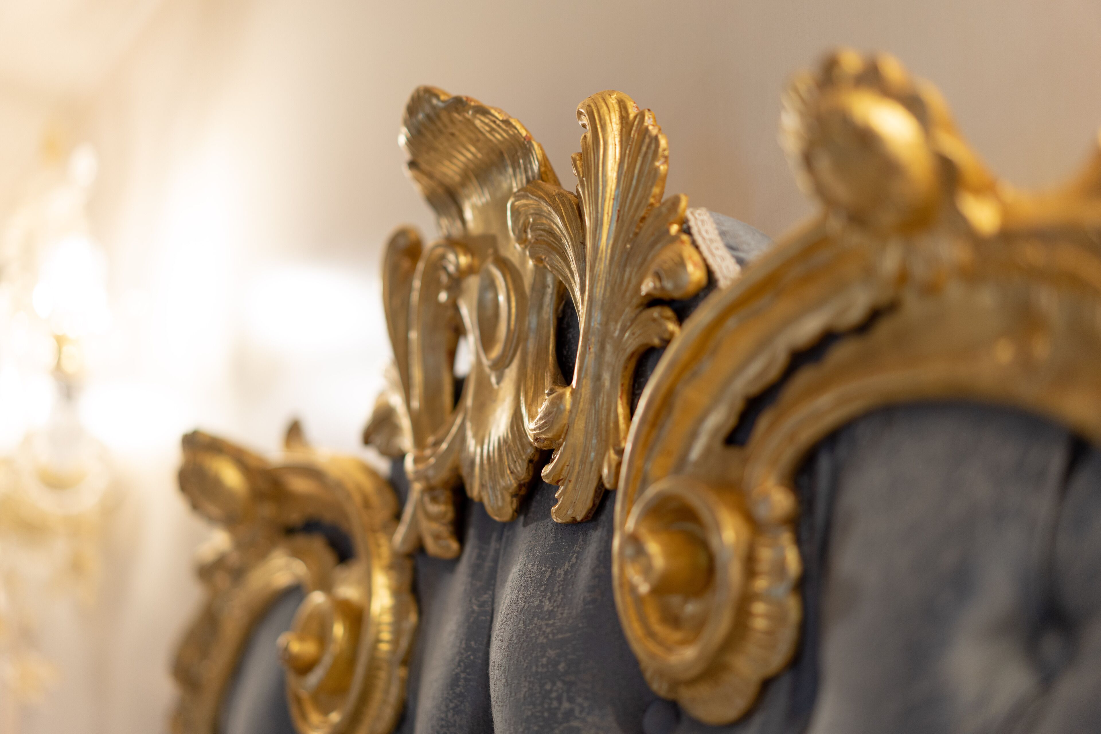 A close-up of ornate golden furniture with intricate designs.