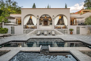 A pool area with a spa, outdoor seating, and a covered patio. - Casa Cien (San Miguel de Allende)