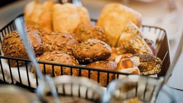 A basket of various breads and pastries.