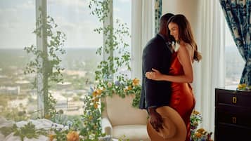 Couples can enjoy a romantic city view from the large window in this cozy retreat.