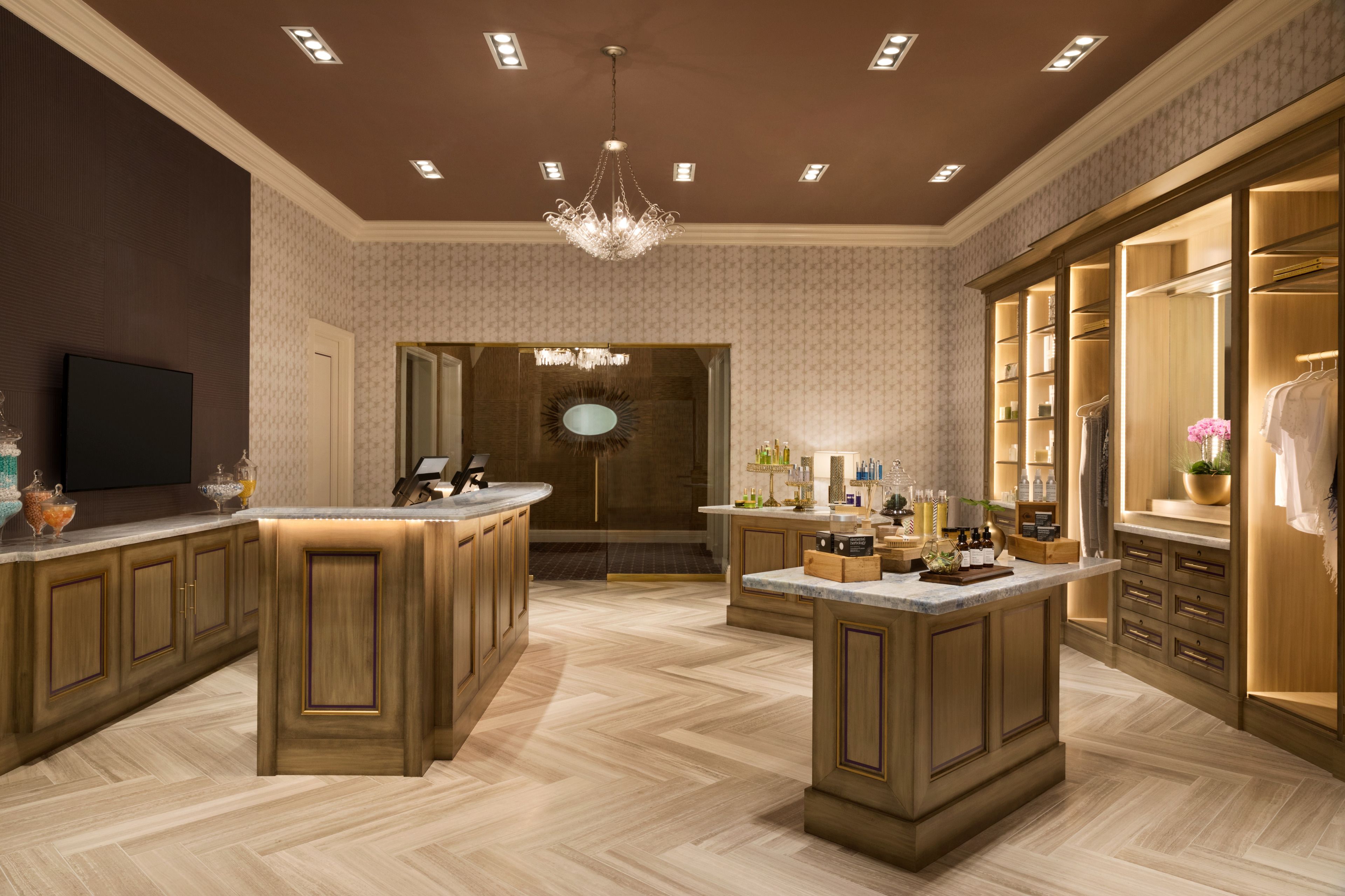 A spacious kitchen with a central island, wooden cabinetry, and a built-in wine rack.
