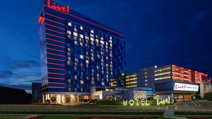 A hotel with a prominent 'Live!' sign, multiple floors, and a well-lit entrance.