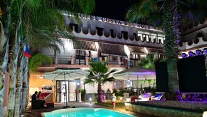 A hotel with a pool area, outdoor seating, and a sign reading "OTEL COSTA DEL SOLE". - Palace Hotel Costa Del Sole (Catania)