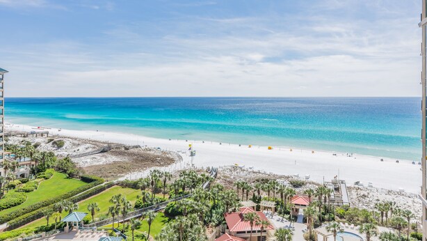 A resort with a beach view, including a pool area and a building with a red roof. - Beachfront at Sandestin (Miramar Beach)