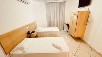 Minibar, escritorio, cortinas blackout y tabla de planchar con plancha