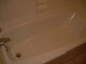 A white bathtub with a single faucet and a drain. - 83 Motel (North Platte)