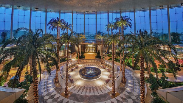 A spacious atrium with a central fountain, surrounded by palm trees and a checkered floor pattern. - Waldorf Astoria Cairo Heliopolis (Cairo)