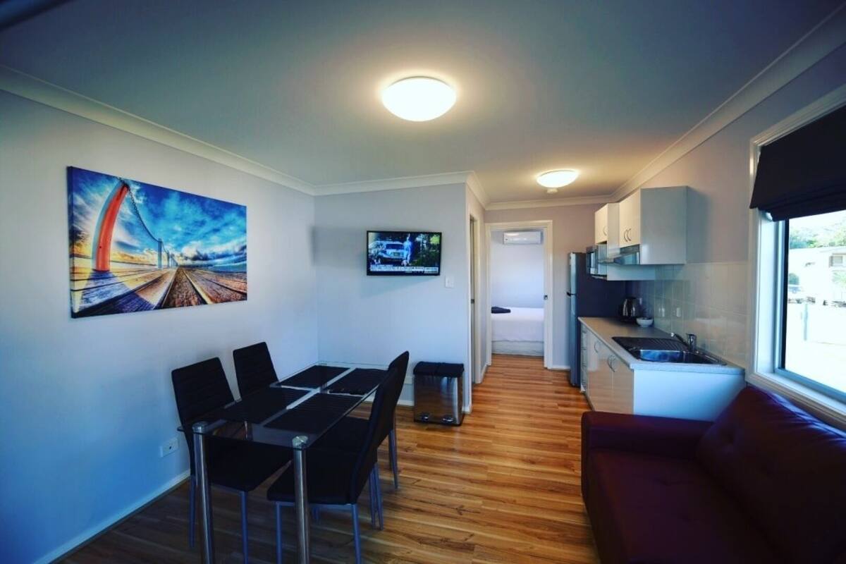Deluxe Riverfront Cabin | Living area | Flat-screen TV