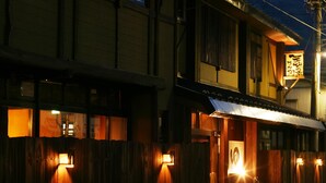 A traditional Japanese building with wooden exterior walls and a signboard. - Nakaya Ryokan (Minakami)
