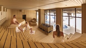 A sauna room with wooden benches and a large window. - TUI MAGIC LIFE Masmavi - All inclusive (Serik)
