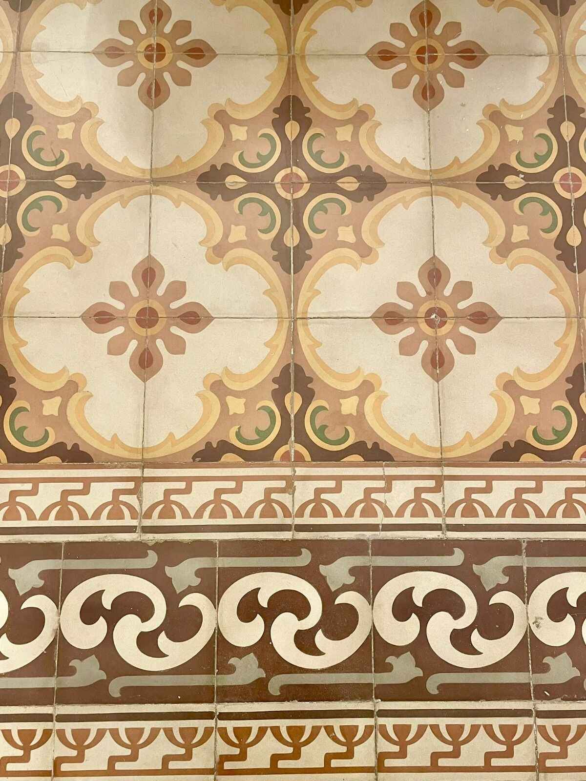 A tiled wall with a repeating geometric pattern.
