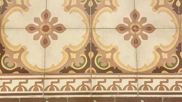 A tiled wall with a repeating geometric pattern.