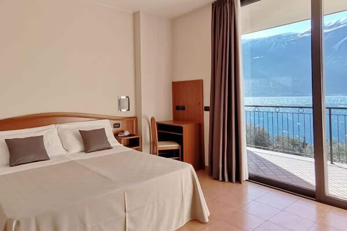 double room, balcony, lake view | minibar, in-room safe, desk, blackout curtains