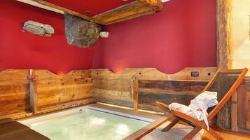 Relax in a serene sauna room with a wooden bench and towel.